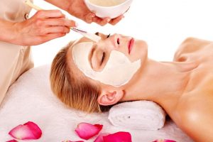 15232721 – woman with clay facial mask with rose petal. isolated. 15232721 - woman with clay facial mask with rose petal. isolated.