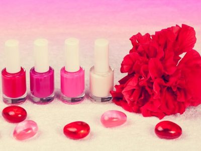 Salon for manicure. Nail polish for french manicure decorated with flower