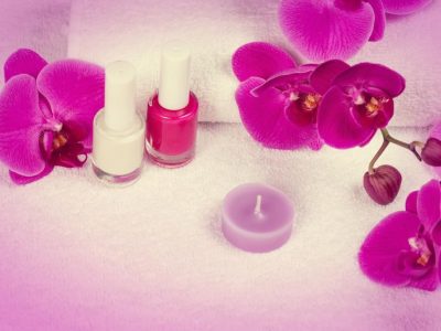 Salon for manicure. Nail polish for french manicure decorated with flower